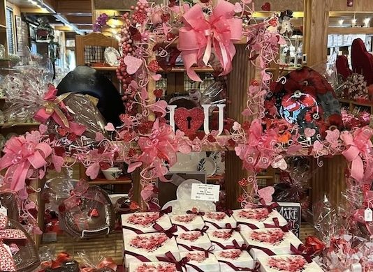 Sweets For Your Sweetie! Valentine's Day candy and gift display with pink bows in a sweet shop